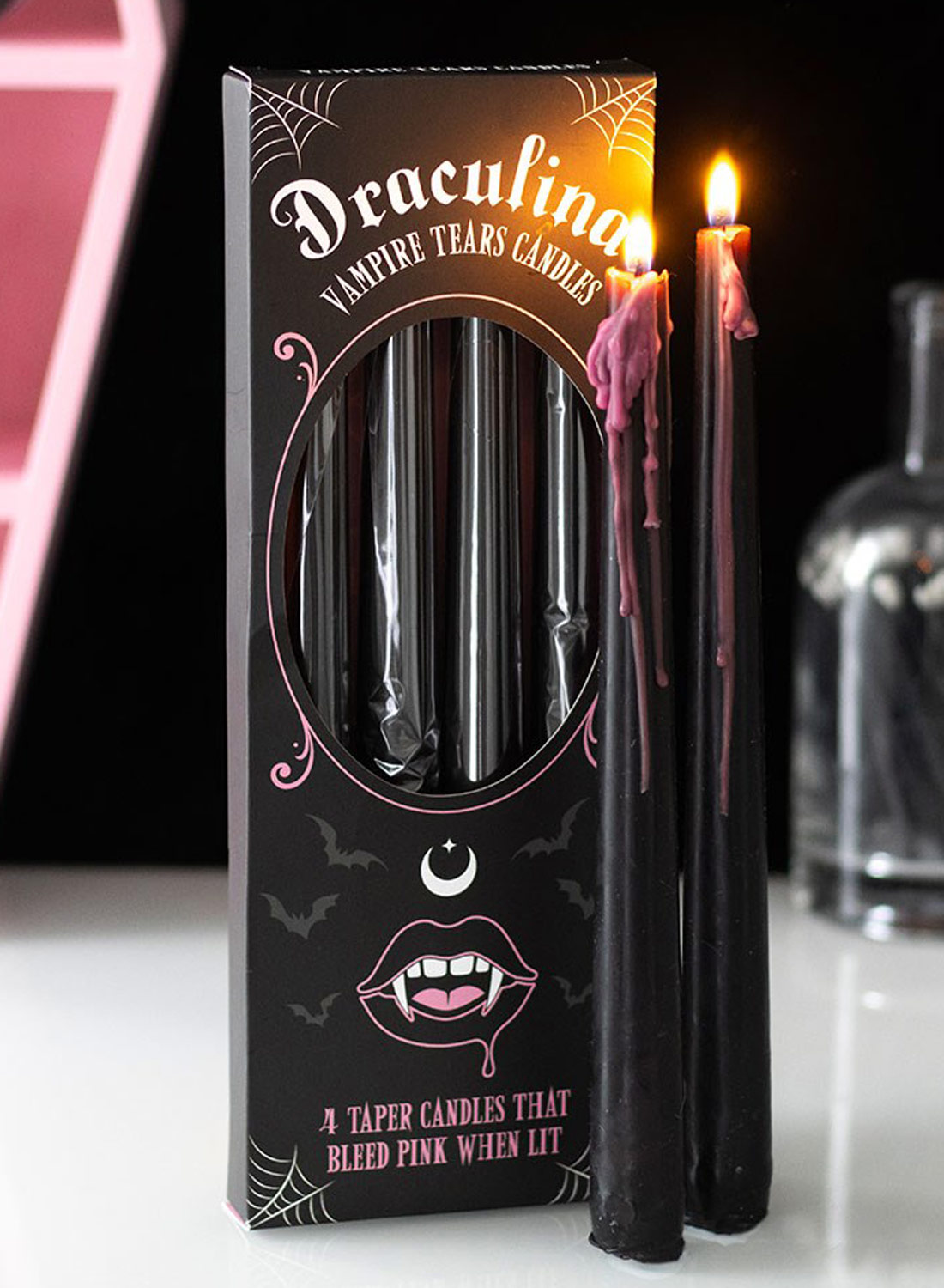 Pink Vampire Tears Candles - four black gothic vampire candles melting with pink wax, displayed with packaging and lit candle.